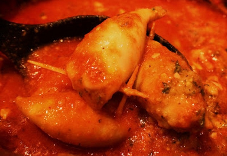 this is how to make one of the 7 fish on Christmas Eve Stuffed Calamari. This calamari is in a rich tomato sauce that has a stuffing inside and is an Italian tradition on Christmas Eve