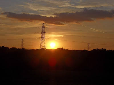 Sunset Through Electric Pylon Towers