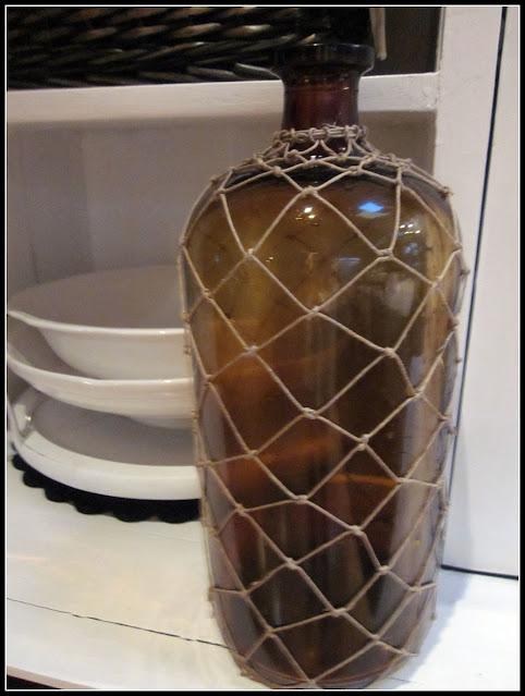 Demijohn with white dishes