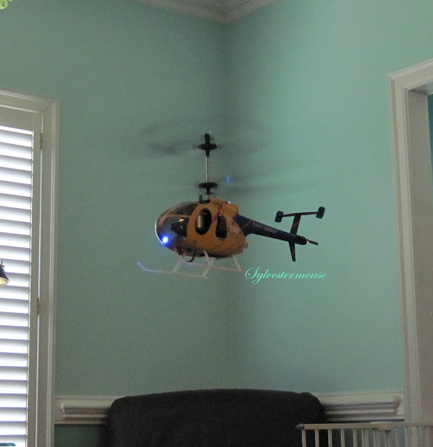 flying a remote control helicopter indoors photo by Sylvestermouse