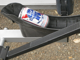 Empty beer can in bike rack tire well.