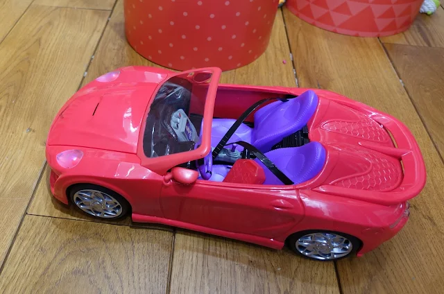 A pinky red remote control car the MC2 dolls can sit in