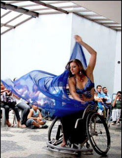A woman doing a veil performance in a wheelchair. Source unknown