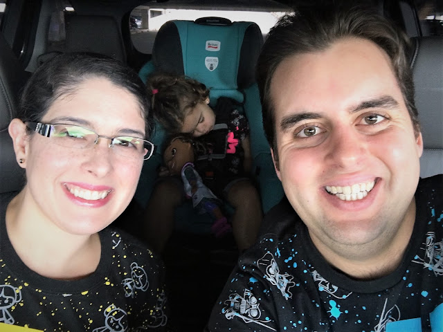 Naptime in the Supercon Parking Structure Parents smiling in the front. Little Leia sleeping in the back.