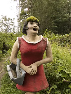 Sculpture of a woman in a red dress at Parikkala Sculpture Park