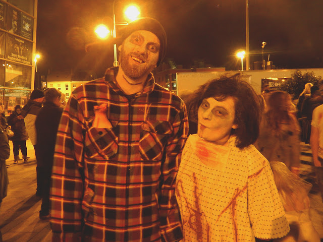 Two people dressed as zombies
