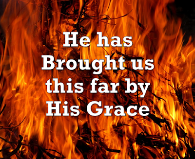 Song title - he has brought us thus far by his grace - superimposed on background of fire.