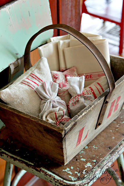 Vintage French trug filled with red and white antique French linens