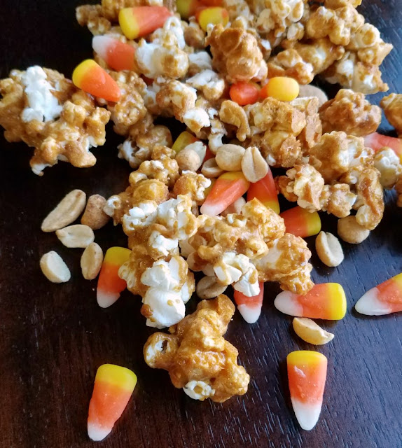 Sweet and salty crunch peanut butter popcorn with candy corn and peanuts for a fun version of hillbilly hash. A favorite fall treat just got upgraded! close up of hillbilly hash popcorn