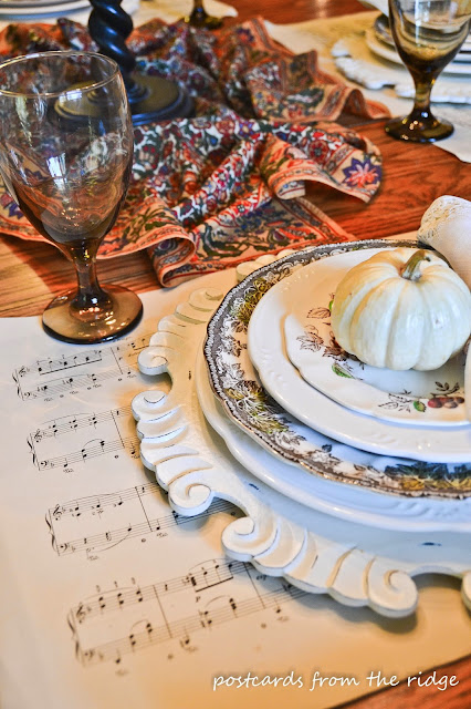 Vintage sheet music for placemats, baby pumpkins, vintage dishes and more in this cozy breakfast room tour from Postcards from the Ridge.