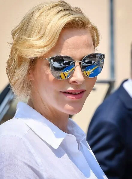 Princess Charlene wore Akris Punto striped flared skirt and white shirt. Prince's Palace of Monaco classical car event