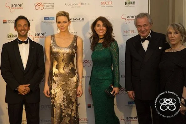 Princess Charlene wore AKRIS Sequined Gown in Gold Metallic at AMREF Gala in evening