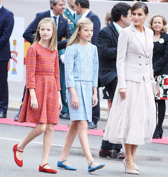 Queen Letizia wore Felipe Varela coat and dress. Crown Princess Leonor and Infanta Sofia attended National Day 2018 parade held at Plaza de Lima