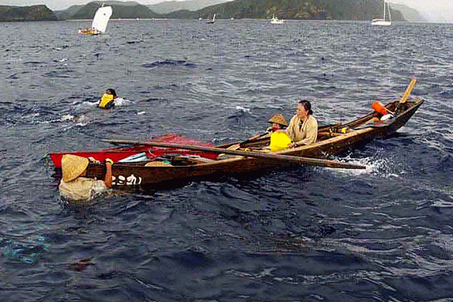 sailboats,swimmer,3 girls, capsized boat, islands, ocean