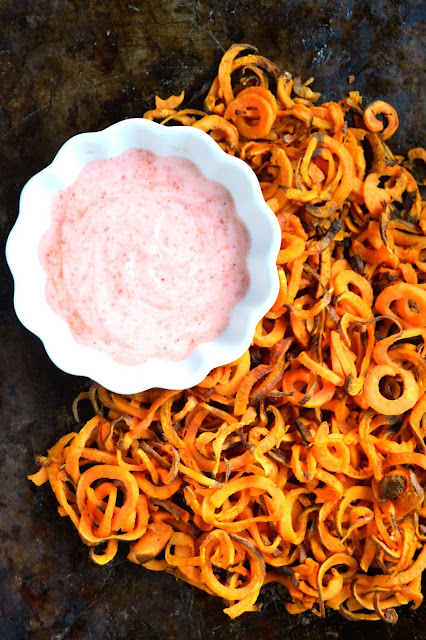 Spiralized Sweet Potato Fries with Chile Habanero Sauce- thin, crispy and make the perfect appetizer. The spicy and creamy sauce adds flavor and spice to the dish. www.nutritionistreviews.com
