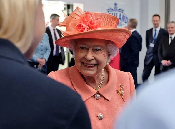 Queen Elizabeth II visited the new Highland Spring factory building in Blackford. The Queen style. wore pink coat and flower dress