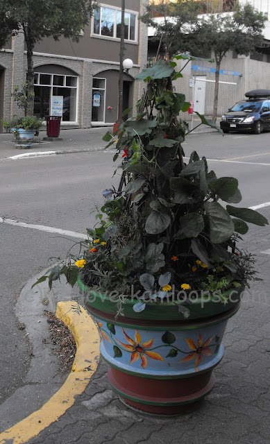 The planter has been painted with colorful flowers.