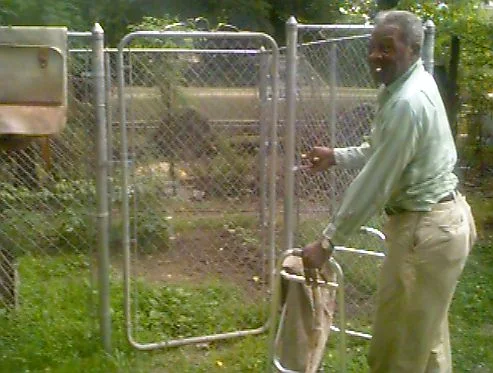 Willie at the gate to his garden.