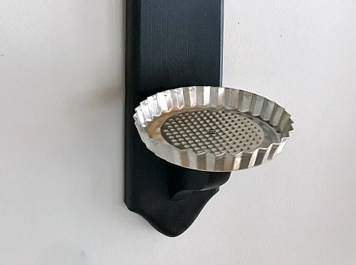 metal tart pan attached to candlestick