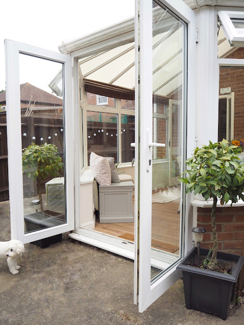 Turn an old unused conservatory into a stylish sunroom with dining table and chairs and blanket box seating area from The Cotswold Company