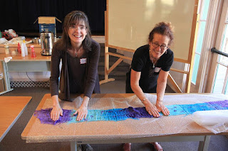 Kim and Sarah scrubbing and fulling a nuno-felted scarf