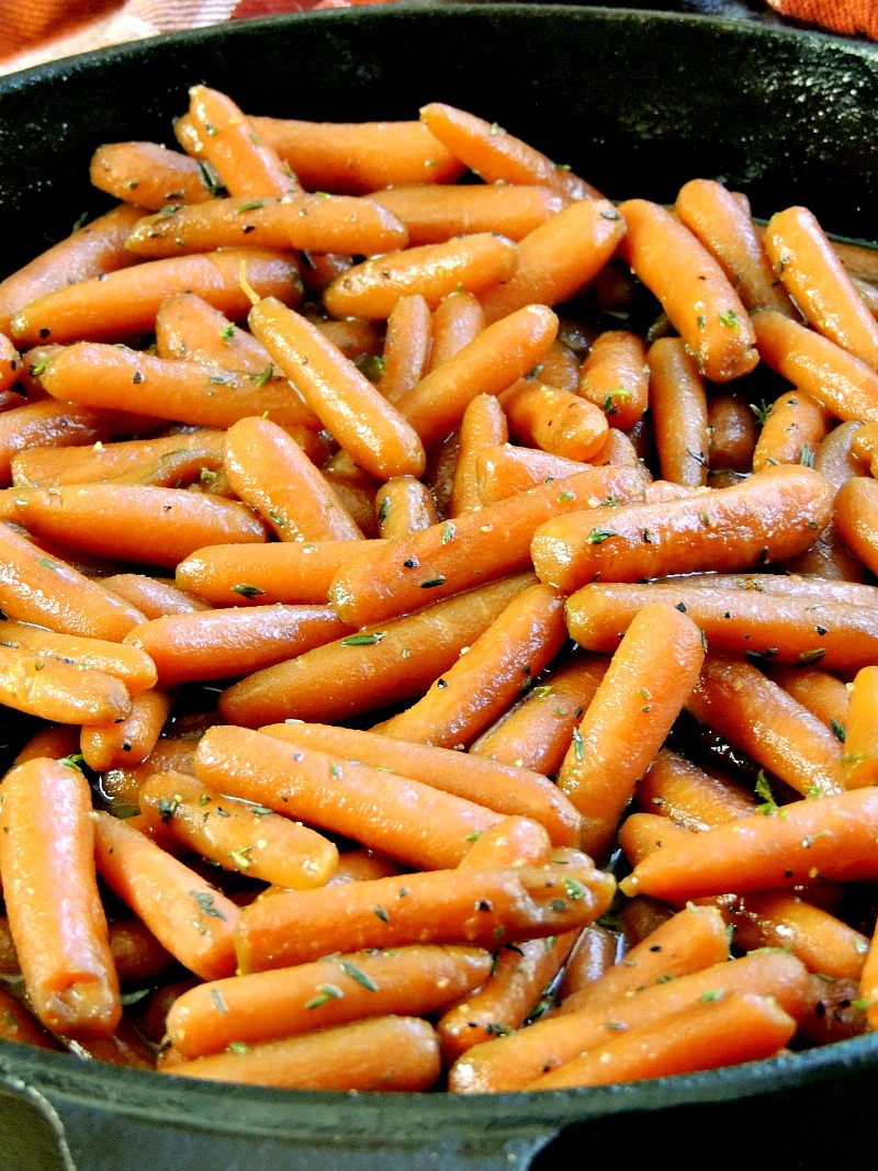 Glazed Carrots with Thyme - These tender baby carrots would be a perfect holiday side dish. Honey glazed, and sprinkled with thyme, your family will request them all year long! #sidedish #carrots #glazedcarrots #vegetarian #honey #thyme #holidayrecipes #easy #recipe | bobbiskozykitchen.com