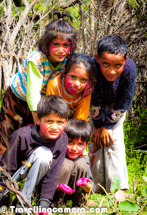 After so many year, I moved towards hills to celebrate the festival of colors - Holi. Initially decided plan was different and finally it was exactly opposite. Let's check out this Photo Journey to know more about the planned Holi and final thing which happened...These are the kids I met on the special day of Holi and everyone of them was very cheerful, as you can see in the photographs. These kids belong to a village called Kehlwin, which is in Una district of Himachal Pradesh. Initial plan was to go to Kangra Fort where Holi is celebrated two days before the actual celebration day. Lot of folks from various parts of India come and just rub their hands of faces of others.. no colors are used and it is considered as one of the old styles of celebrating Holi in Kangra Kingdom. I wanted to witness this but could not make itIn Himachal, Sujanpur is another place where Holi is celebrated for a week and a huge fair is organized by Hamirpur authorities. Some popular bollywood singers and performers can be seen during evenings on Sujanpur Holi FairHere is a photograph of most innocent kid who was not very keen in putting color on others. At the same times, he is easiest target for everyone :) ... When I asked him to pose for my TravellingCamera, he stood like a army-man with nice salute position as you can see in photograph above...Holi is a religious spring festival celebrated by Hindus. Holi is also known as festival of Colors. It is primarily observed in India, Bangladesh, Pakistan, Nepal and also in Malaysia, Guyana, South Africa, Trinidad, United Kingdom, United States, Mauritius, and Fiji. The most celebrated Holi is in the Braj region, in locations connected to the Lord Krishna: Mathura, Vrindavan, Nandagaon, and Barsana. These places have become tourist destinations during the festive season of Holi.Originally, it was a festival that commemorated good harvests and the fertile land. In addition to celebrating the coming of spring, Holi has even greater purposes. Hindus believe it is a time of enjoying spring's abundant colors and saying farewell to winter. Holi celebrates many religious myths and legendsIn most areas, Holi lasts about two days. One of Holi’s biggest customs is the loosening strictness of social structures, which normally include age, gender, status, and caste. Holi closes the wide gaps between social classes and brings Hindus together. Together, the rich and poor, women and men, enjoy each other’s presence on this joyous day. Additionally, Holi lowers (but does not remove completely) the strictness of social norms. No one expects polite behavior... as a result, the atmosphere is filled with excitement and joy.