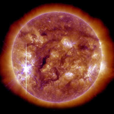This handout picture released by the NASA and coming from the Solar Dynamics Observatory (SDO) on November 5, 2013 shows the Sun brightened when an X-class solar flare—the largest so far this year—burst from a large, active sunspot. The flare followed a series of more than a two dozen flares that have occurred since October 21, though the November 5 flare originated in a different active region. The event was classified an X3.3 flare, falling into the category of most intense explosions. This view of the flare comes from NASA’s Solar Dynamics Observatory (SDO), and it shows the Sun in extreme ultraviolet light (blending 193 and 131 angstrom observations). The long streak of light is likely due to solar protons saturating the imager. The unusual color is due to the blending of false colors that are assigned to each wavelength by solar physicists to distinguish the different bands. The image is from 5:12 p.m. Eastern Standard Time (22:12 UTC), the peak of the short flare.