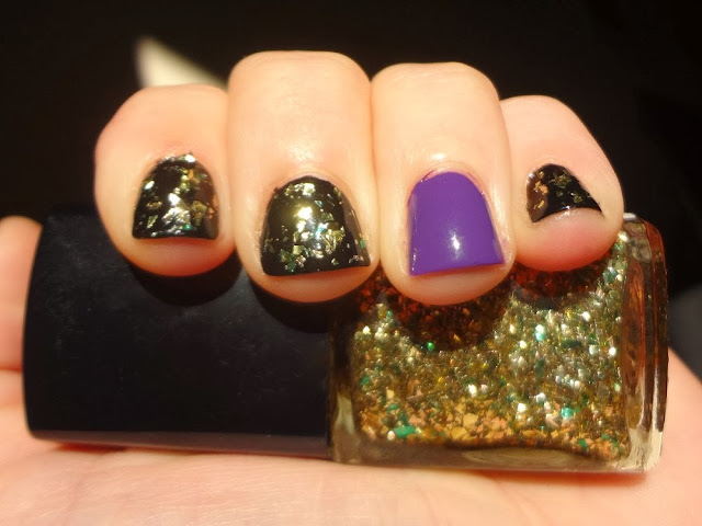 Black nails with gold and green flakes, purple accent nail, halloween nails