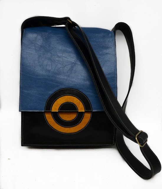Blue, yellow, and black leather Chemical Wedding shoulder handbag with adjustable strap.