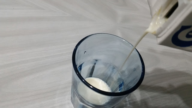 Pouring milk in an empty glass