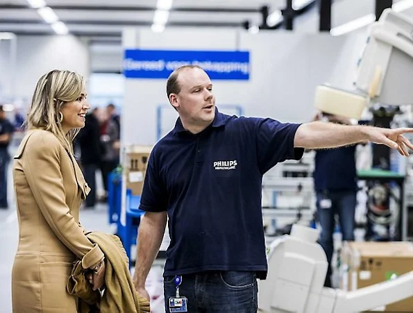 Employees of Philips' Innovation and Production Centre in Best take pictures of Netherlands' Queen Maxima during a visit