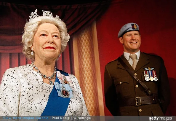 Wax figures of British Royal Family members Queen Elizabeth II and Prince Harry are unveiled at Madame Tussauds on May 5, 2015 in Washington, DC
