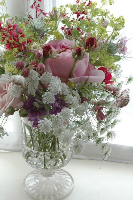 Roses, ammi majus, nigella and astrantia in a vintage glass vase. By Tuckshop Flowers