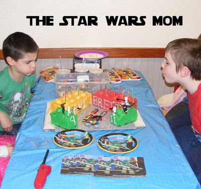 Blowing out the candles on Lego Star Wars cakes.