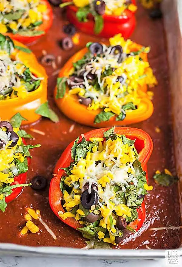 Vegetarian Stuffed Peppers a top tomato sauce with melted cheese in a baking dish ready to serve for dinner