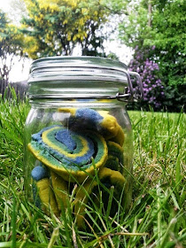 Yellow, green, blue cookies in jar