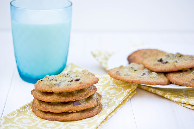 Cookies on a napkin with a glass of milk