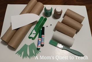 paper towel rolls, green paint, paintbrushes, and other craft supplies