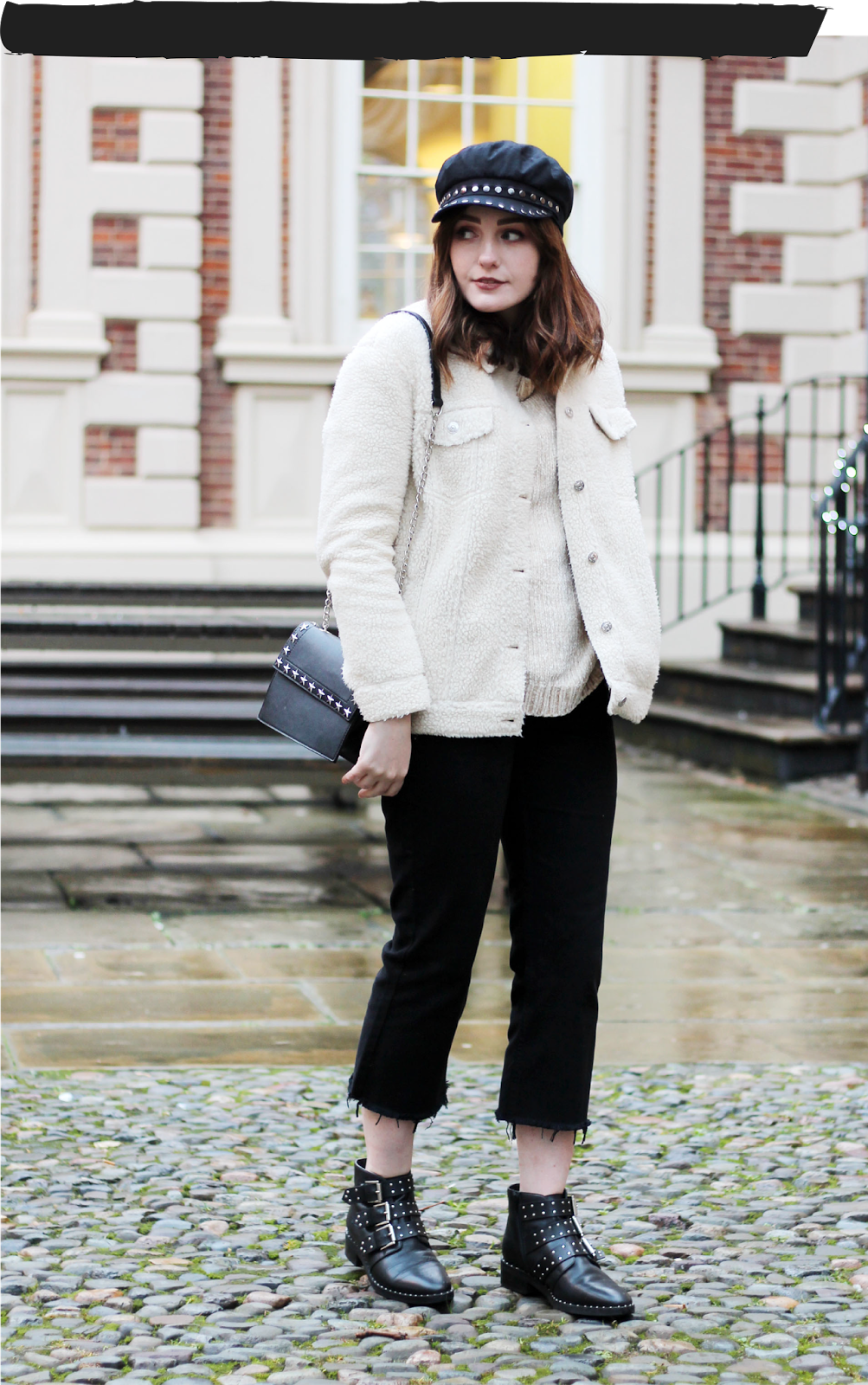 fashion blogger wearing cream chenille jumper and borg jacket, black cropped wide leg jeans, studded boots, bag and baker boy cap