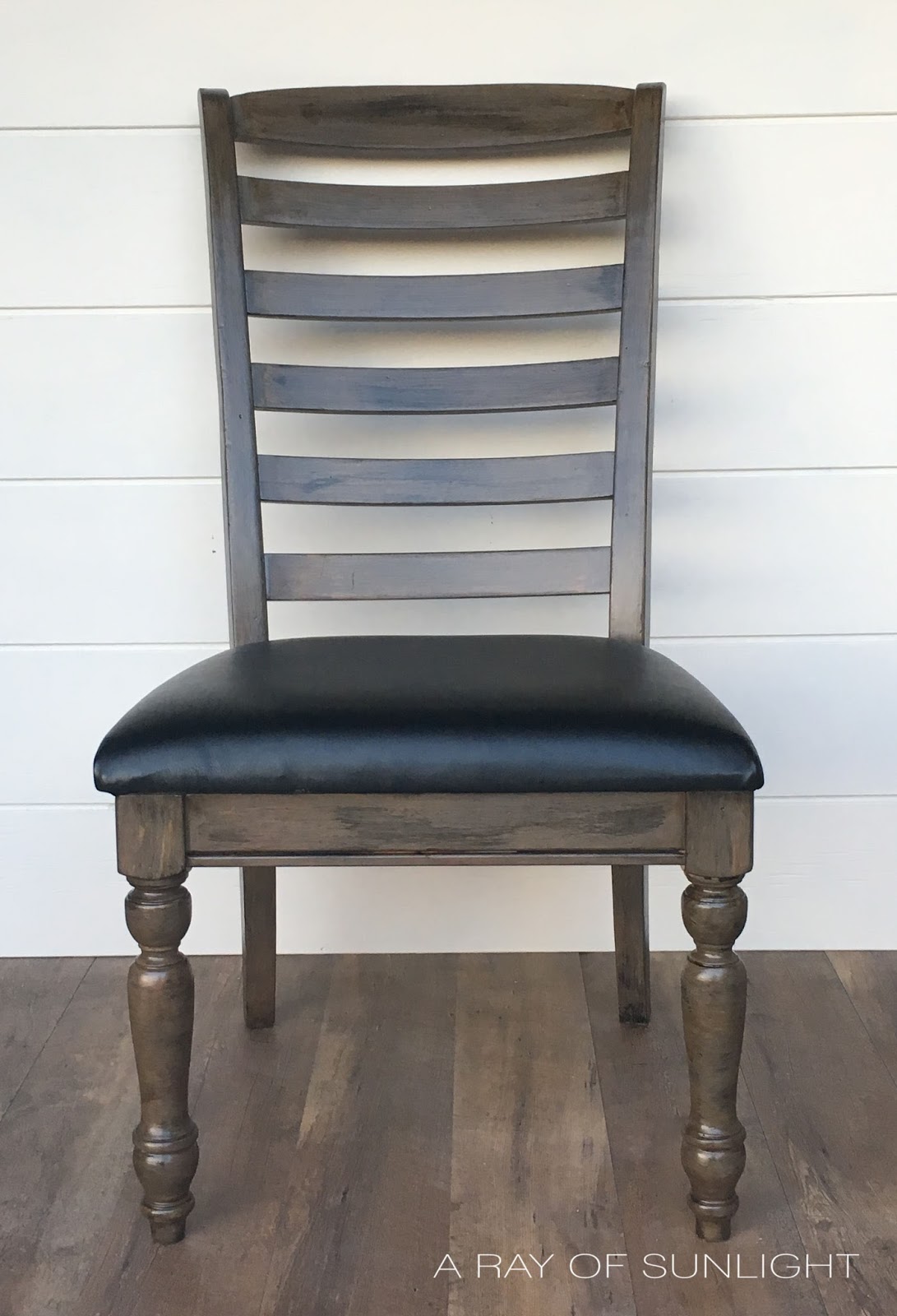 Chair after restoration hardware weathered finish with paint and reupholstered with black vinyl seat