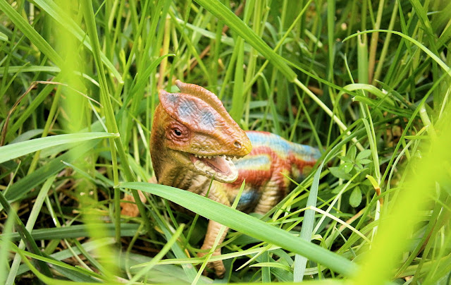 dinosaur in grass realistic toy real