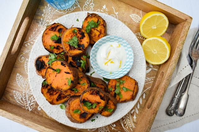 Grilled Tandoori Sweet Potato Slices serve on a plate with lemon mayonnaise and a wedge of lemon