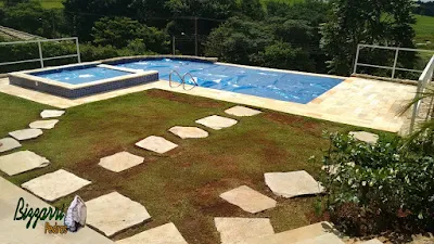 Bizzarri organizando para executar os caminhos de pedra no jardim em volta da piscina sendo a execução do caminho de pedra Carranca tipo cacão com junta de grama em casa em condomínio na represa de Piracaia-SP.