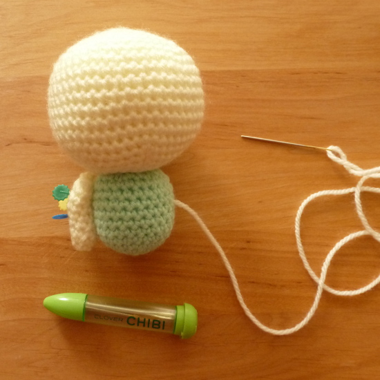 Clover Chibi set and amigurumi crochet toy being sewn up with needle and yarn