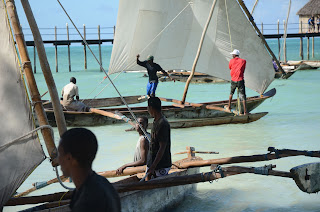 jambiani beach in zanzibar, boats with rocker at high tide