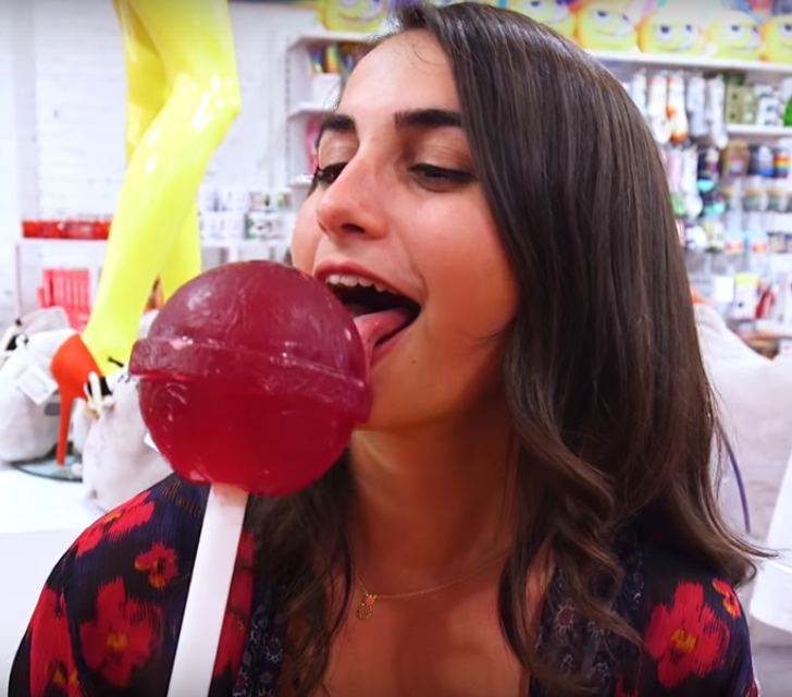 Girl licking a giant candy