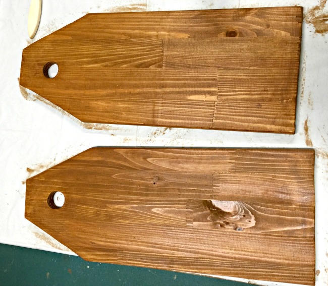two wooden boards cut to tag shapes