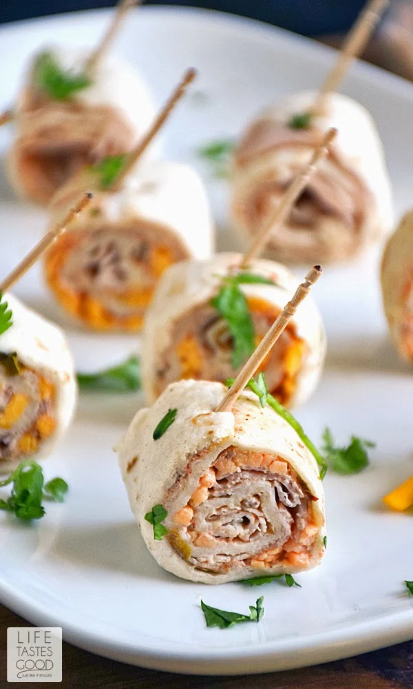 Turkey Taco Bites | by Life Tastes Good combine classic taco flavors with sliced turkey all rolled up into a bite sized morsel of deliciousness! It makes a tasty appetizer that is quick and easy too. If you have 5-10 minutes you can whip these up ahead of time and refrigerate until ready to enjoy! It doesn't get much better than that for quick and easy party food! Perfect for #TacoTuesday