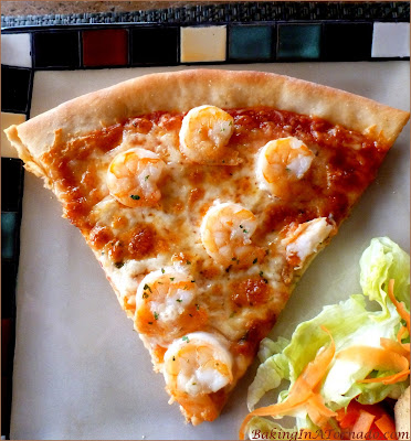 Rosemary Infused Shrimp Scampi Pizza: A crunchy rosemary infused pizza crust topped with homemade marinara, melted cheese and scampi flavored shrimp | Recipe developed by www.BakingInATornado.com| #recipe #pizza #shrimp